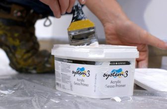 Pots of gesso primer with a flat brush