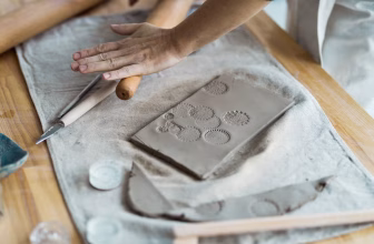 White air dry clay with modelling tools on a table